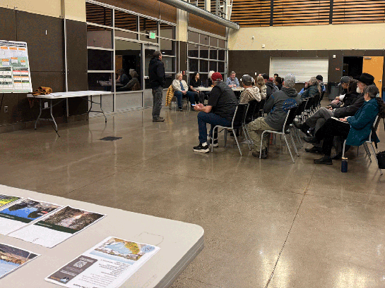 Yelm City planners stand in front of seated crowd at Yelm Community Center.